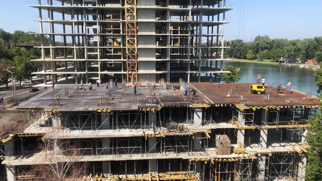 Builders at the construction site. Working process at the construction site. Construction work.