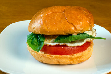 fried egg  on tomato with spanch on top
