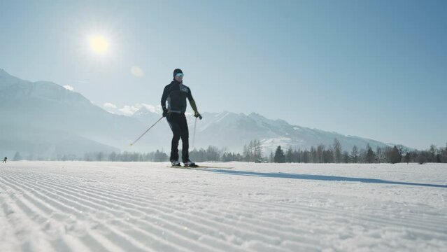 Cross Country Skier Skiing Along Snowy Path