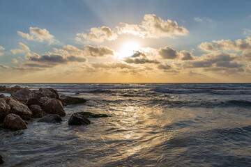 Obraz premium Beautiful summer sunset at the breakwater on the Mediterranean Sea. Israel.