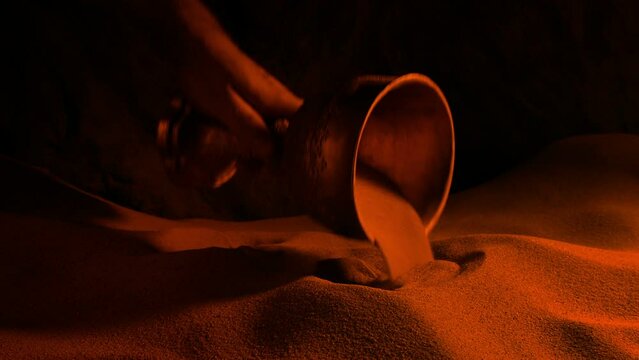 Man Picks Up Gold Treasure Cup In Firelight