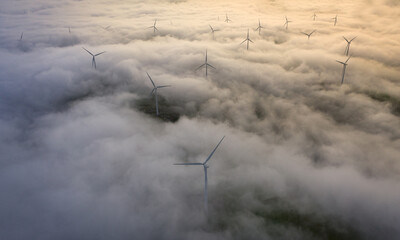 A wind farm rises above a thick blanket of morning fog, Bay Area, California, USA