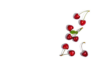 Ripe sweet cherries with fresh mint leaves isolated on white background. Traditional summer fruits