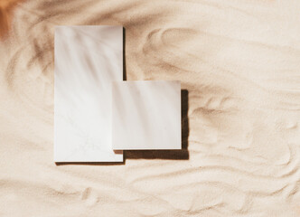 Creative summer podium of marble tiles background of sand, copy space, sunlight and shadows, mockup