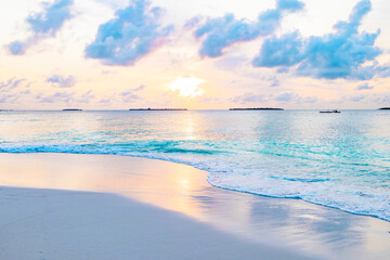 picturesque sunrise in the Maldives island, the sun rising from the Indian ocean and reflected in the water, travel concept