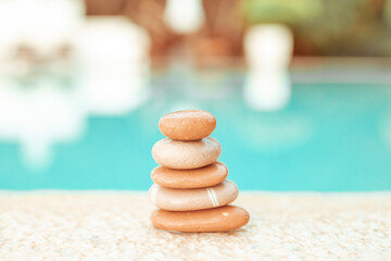 pyramid of stones by the sea at dawn, balanced zen stones, spa and relax concept, meditation