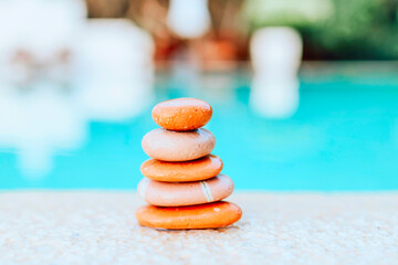 pyramid of stones by the sea at dawn, balanced zen stones, spa and relax concept, meditation