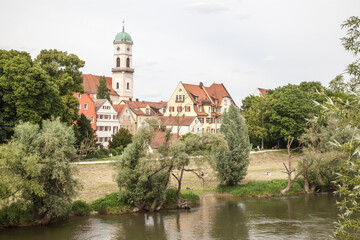 Fototapeta na wymiar Scenic spring view of old buildings at Danube river pier and street architecture in the Old Town of Regensburg, Bavaria, Germany