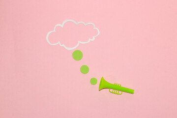 green trumpet advertising, three dots leading from trumpet to cloud as copy space, pink background...
