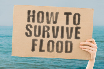 The phrase " How to survive war " is on a banner in men's hands with blurred background. Water. Environment. Natural. Climate. Weather. Home. House. Damage. Danger. Destruction. Emergency. Insurance