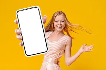 Cheerful Blonde Lady Showing Smartphone With Empty Screen