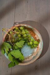 green grapes in rustic clay pot
