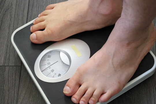 Whit Man Feet On Bathroom Scales , Weight Check