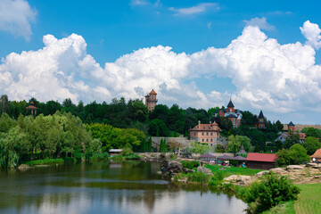 Fototapeta na wymiar beautiful view of the lake and the castle in Buky Landscape Park, Ukraine. Blue sky with beautiful clouds