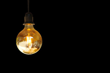 Yellow light bulb isolated on black background.