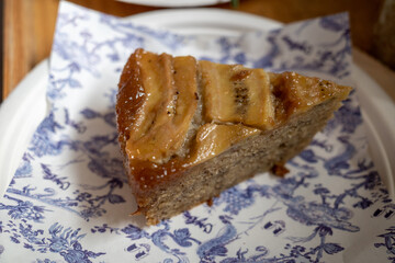 Top view, piece of sliced banana cake on napkin.