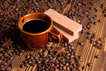 ceramic brown cup with black coffee and grains on wooden background still life