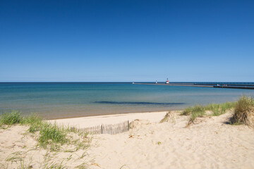 Sand beach and beachgrass with St. Joseph North Pier Inner Lighthouse and St. Joseph North Pierhead Outer Lighthouse, Michigan in background
