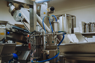Olive oil plant. Olive farm with a factory. Machines for the production of olive oil and packaging.