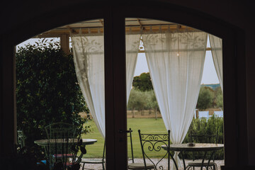 Beautiful Italian-style terrace in a field with olive fields in the background. Comfort and relaxation, boho style.