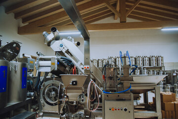 Olive oil plant. Olive farm with a factory. Machines for the production of olive oil and packaging.
