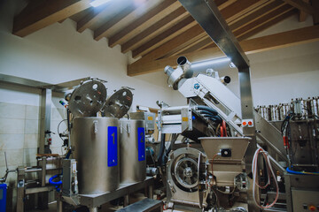 Olive oil plant. Olive farm with a factory. Machines for the production of olive oil and packaging.
