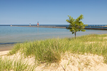 Sand beach and beachgrass with St. Joseph North Pier Inner Lighthouse and St. Joseph North Pierhead...
