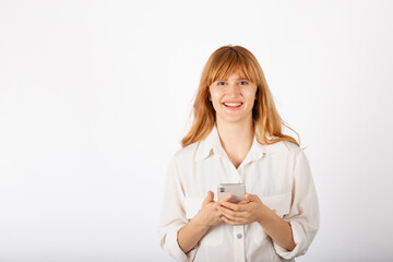 Fototapeta premium Young businesswoman portrait with smartphone in studio.