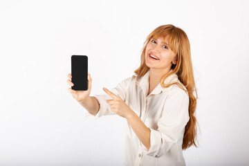 Young businesswoman portrait with smartphone in studio.