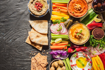 Arabic Cuisine;  Middle Eastern Hummus platter with assorted snacks. Hummus dip with fresh...