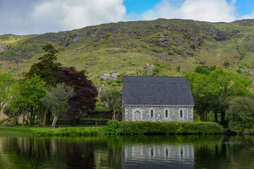 Fototapeta na wymiar Gougane Barra, Co. Cork, Ireland: 19th-century oratory built on a small island in Gougane Lake, a scenic valley and heritage site in the Shehy Mountains.