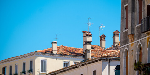 Fototapeta na wymiar Architecturally beautiful Venetian roofs set against a turquoise blue sky.