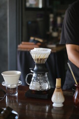 person pouring tea into a glass