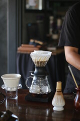 person pouring coffee into a glass