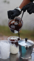 Closeup of Iced Caramel Macchiato at the coffee shop, Caramel Macchiato is a classic macchiato beverage. It consists of vanilla syrup, espresso, steamed milk, foam, and caramel drizzle