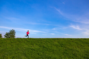 Young Asian girls jogging for fitness in the open grass