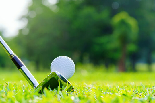 Golf ball on green grass ready to be struck on golf course
