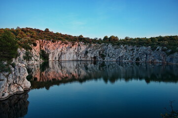 Rock formation reflected in water of lake