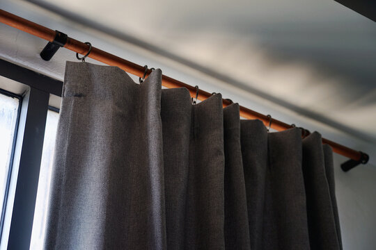 UV Resistant Gray Curtains Installed In The Windows Of Bedroom.