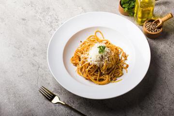 Italian Pasta spaghetti bolognese with minced beef sauce and parmesan cheese in white plate on texture table