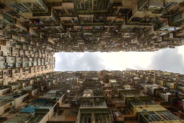 Low angle view of crowded residential towers in an old community in Quarry Bay, Hong Kong ~ Scenery of overcrowded narrow apartments, a phenomenon of high housing density & housing blues in HK - obrazy, fototapety, plakaty