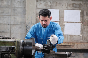 One professional Asian male industry engineer worker works in a safety uniform with metalwork...