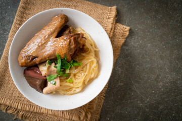 dried noodles with braised duck in white bowl