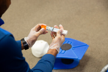 Staff training to inject an epinephrine as first aid - obrazy, fototapety, plakaty