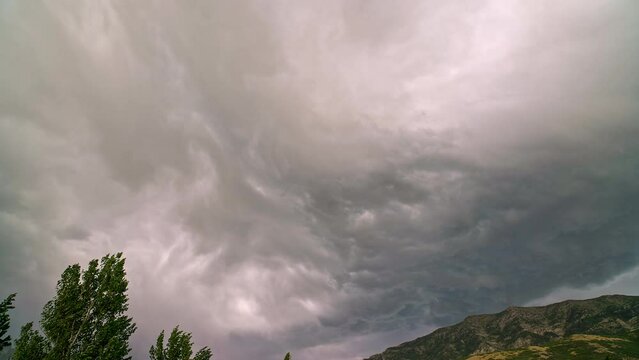 Storm clouds moving in timelapse over Cascade Mountain in Utah during extreme weather warning.