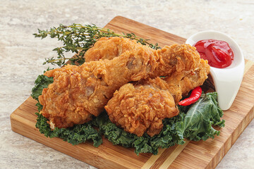 Fried chicken drumsticks with tomato sauce