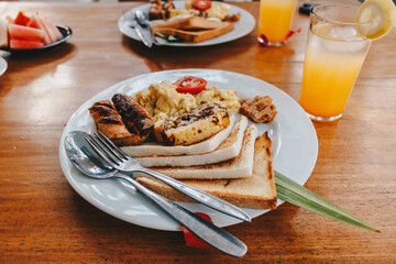 Breakfast set with orange juice on the table.