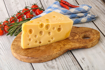 Maasdam cheese piece over board