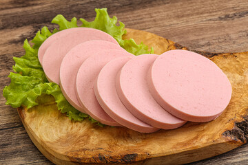 Sliced sausage snak over board