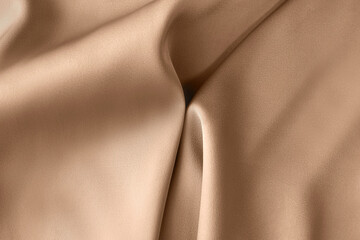 Luxury light brown beige color creased smooth satin silk cloth texture decorate background with...